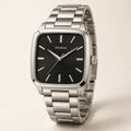 Danlous Monaco, square silver-tone case with rounded corners, black dial, baton markers and silver-tone link bracelet, main studio view